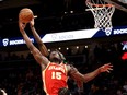 Jan 31, 2022; Atlanta, Georgia, USA; Atlanta Hawks center Clint Capela (15) and Toronto Raptors forward Chris Boucher (25) fight for a rebound during the second quarter at State Farm Arena.