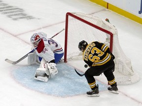 Bruins' Brad Marchand beats Canadiens goalie Jake Allen for the first of his three goals Wednesday night in Boston.