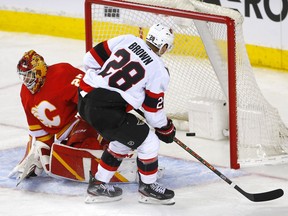 Ottawa Senators scores Connor Brown on Calgary Flames goalie Jacob Markstrom in third period NHL action at the Scotiabank Saddledome in Calgary on Thursday, Jan. 13, 2022.