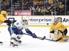 Nashville Predators goaltender David Rittich (33) stops the shot of Vancouver Canucks right wing Vasily Podkolzin (92) during the second period at Bridgestone Arena.