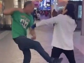 Screenshot of man in green t-shirt fighting with a Michael Jackson impersonator.