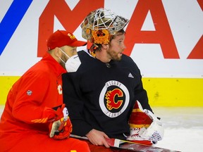 Calgary Flames goalie coach Jason Labarbera and goaltender Jacob Markstrom are pictured during practice at the Scotiabank Saddledome on Dec. 26, 2021.