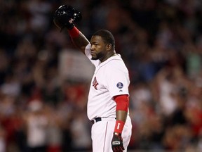 Boston Red Sox designated hitter David Ortiz stands safe at second base and salutes the crowd after hitting his 2000th career hit in the sixth inning against the Detroit Tigers during their MLB American League Baseball game in Boston, Massachusetts, September 4, 2013.