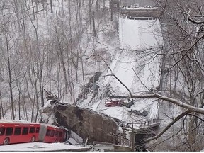 Vehicles sit on a collapsed bridge in Pittsburgh, Pennsylvania, U.S. January 28, 2022, in this image obtained from a social media video.