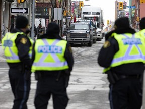 Police officers patrol on a downtown Ottawa street during the anti-mandate protest on Wednesday.