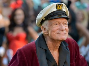 Hugh Hefner poses at Playboy's 60th Anniversary special event on January 16, 2014 in Los Angeles, California.