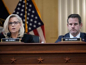 In this file photo taken on Dec. 1, 2021, U.S. Republican Representatives Liz Cheney and Adam Kinzinger listen during a select committee investigating the attack on the U.S. Capitol in Washington, D.C.