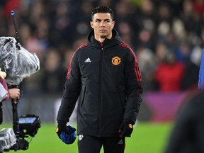 Manchester United's Portuguese striker Cristiano Ronaldo gestures before taking his place on the substitute's bench before the English Premier League football match between Burnley and Manchester United at Turf Moor in Burnley, north west England on February 8, 2022. - (Photo by PAUL ELLIS/AFP via Getty Images)