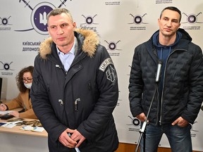 Kyiv mayor Vitali Klitschko (left) and his brother and former boxer Wladimir Klitschko speak to the press in Kiev on February 2, 2022.