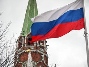 A Russian flag waves next to one of the Kremlin towers in downtown Moscow on Feb. 26, 2022.