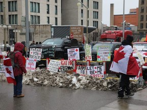 Signs of support for the Freedom Convoy protest are seenn on Wellington Street in Ottawa, Thursday, Feb. 10, 2022.