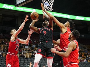 Toronto Raptors forward Precious Achiuwa goes up to make a basket as Chicago Bulls guard Matt Thomas and center Tony Bradley defend during the first quarter at Scotiabank Arena.