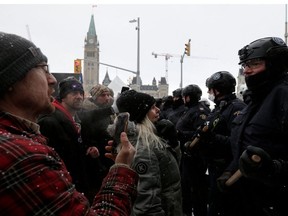 Canadian police officers face off with demonstrators, as they work to restore normality to the capital while trucks and demonstrators continue to occupy the downtown core for more than three weeks to protest against pandemic restrictions in Ottawa, Ontario, Canada, February 19, 2022.