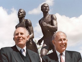 England’s Sir Roger Bannister (left) and Australia’s John Landy pose in Vancouver in a 1994 file photo. The statue behind them commemorates their mile race at the British Empire Games in Vancouver in 1954.