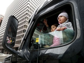 Two children attend the "Freedom Convoy" occupation in Ottawa Sunday.