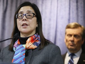 Dr. Eileen de Villa, the Medical Officer of Health for the City of Toronto, speaks at a press conference as Mayor John Tory listens.