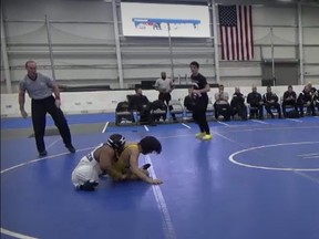 Screenshot of two high school wrestlers, one of whom was born without legs.
