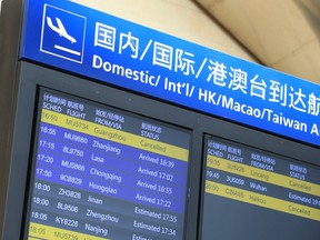 A flight information board shows a cancelled China Eastern Airlines flight (top L) at the Kunming Changshui International Airport in China's southwestern Yunnan province on March 21, 2022, after a China Eastern aircraft flying from Kunming to the southern hub of Guangzhou crashed in southwestern China.