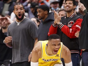 Russell Westbrook of the Los Angeles Lakers celebrates a game-tying basket against the Raptors on Friday night. Drake looks on in the background.