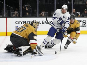 Maple Leafs' Auston Matthews gets hooked by Zach Whitecloud of the Golden Knights during their Jan. 11 game at T-Mobile Arena. No penalty was called on the play.