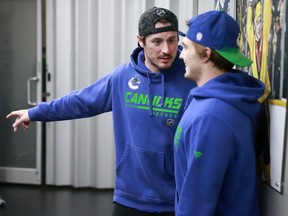 J.T. Miller, shown here talking to Nils Hoglander, extended his point streak to 11 games on Friday with a pair of assists, giving him seven goals and 16 assists over that stretch.