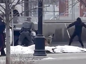 A video still taken from an unidentified source shows a confrontation between Calgary police and a man on February 19, 2022 on 17 Ave SE in Calgary. During the confrontation the man was shot and killed. The man, identified by friends as Latjor Tuel, died after an altercation with police where he allegedly attacked a police service dog with a weapon.