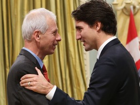 Canadian Prime Minister Justin Trudeau speaks with his Minister of Foreign Affairs Stephane Dion during a swearing-in ceremony at Rideau Hall in Ottawa on November 4, 2015.