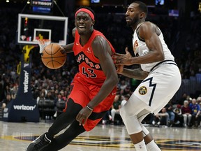 Toronto Raptors forward Pascal Siakam drives on Denver Nuggets guard Davon Reed during the third quarter at Ball Arena in Denver on March 12, 2022.