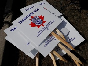Teamsters union picket signs are stacked outside Canadian Pacific Railway's (CP Rail) Toronto Yard after the company halted operations and locked out employees over a labor dispute, in Scarborough, Ont., Sunday, March 20, 2022.