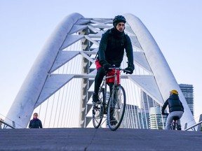 A cyclist crosses Humber Bay Arch Bridge during sunrise in Toronto on Friday, November 5, 2021.