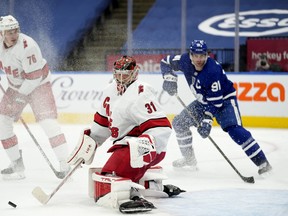 Carolina Hurricanes goaltender Frederik Andersen (31) makes a save during second period NHL hockey action against the Toronto Maple Leafs, in Toronto, Monday, Feb. 7, 2022.