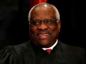 U.S. Supreme Court Justice Clarence Thomas participates in taking a new family photo with his fellow justices at the Supreme Court building in Washington, D.C., June 1, 2017.