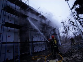 Rescuers extinguish fire following an attack by Russian forces on a television tower in Kyiv, Ukraine March 1, 2022.