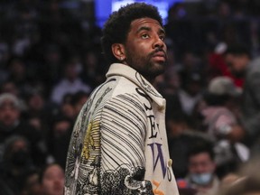 Nets guard Kyrie Irving enters Barclays Center during the second quarter of a game against the Knicks, in Brooklyn, N.Y., Sunday, March 13, 2022.