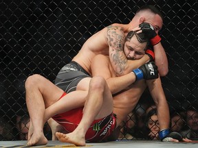 Colby Covington (red gloves) fights Jorge Masvidal (blue gloves) during UFC 272 at T-Mobile Arena.