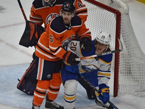 Edmonton Oilers defenceman Kris Russell (6) keeps the Buffalo Sabres' Cody Eakin (20) in check at Rogers Place in Edmonton on Thursday, March 17, 2022.