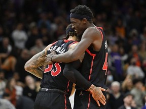 Raptors' Gary Trent Jr., left, and Pascal Siakam, right, celebrate after defeating the Suns 117-112 at Footprint Center in Phoenix, Friday, March 11, 2022.