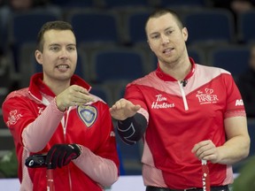 Team Canada skip Brendan Bottcher (left) and third Patrick Janssen discuss strategy during the 2022 Tim Hortons Brier in Lethbridge.