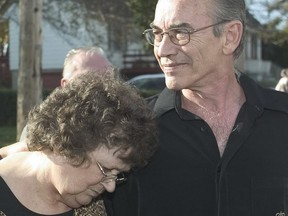 Marlene Truscott rests her head on Steven during a news conference outside their Guelph home on Thursday, Oct. 28, 2004.