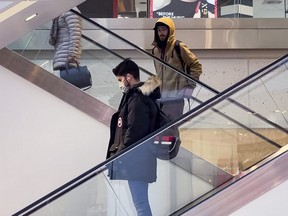 Escalators at the Rideau Centre in Ottawa had some customers wearing masks, and some not, Monday, March 21, 2022.