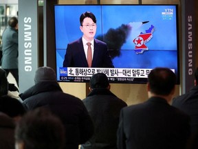 People watch a TV broadcasting a news report on North Korea's firing a ballistic missile off its east coast, in Seoul, South Korea, March 5, 2022.