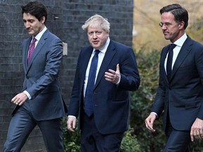 Canadian Prime Minister Justin Trudeau (L) walks with British Prime Minister Boris Johnson (C) and Netherlands Prime Minister Mark Rutte (R) in London, England, on March 7, 2022.