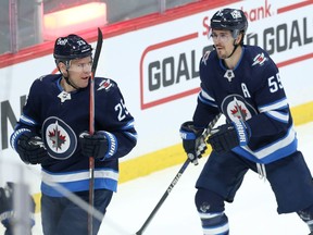 Winnipeg Jets forward Paul Stastny (left) celebrates his goal against the Tampa Bay Lightning in Winnipeg with Mark Scheifele on Tuesday, March 8, 2022.