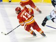 Calgary Flames Johnny Gaudreau against Seattle Kraken Matty Beniers during the third period of NHL action at Scotiabank Saddledome on Tuesday, April 12, 2022.