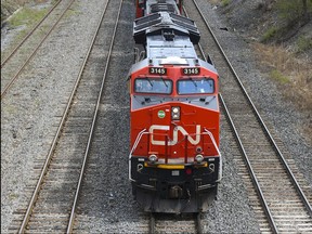 A Canadian National Railway locomotive pulls a train in Montreal, Quebec, Canada, on Tuesday, April 20, 2021. Christinne Muschi/Bloomberg