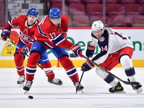 Canadiens winger Josh Anderson and Gustav Nyquist of the Columbus Blue Jackets pursue the puck during the third period at the Bell Centre on Feb. 12, 2022, in Montreal.
