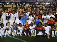 Players of Canada and staff members celebrate qualifying to Qatar 2022 and finishing first in Concacaf after a match between Panama and Canada at Rommel Fernandez Stadium on March 30, 2022 in Panama City, Panama.