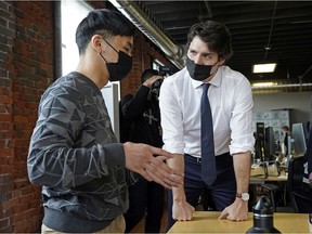 Prime Minister Justin Trudeau (right) speaks with an entrepreneur at Start Up Edmonton on Tuesday April 12, 2022. Prime Minister was in Edmonton to promote the 2022 federal budget.