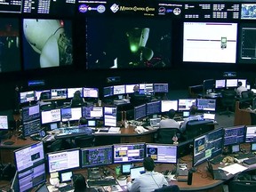 In this screengrab from a NASA TV broadcast the SpaceX control room technicians in Hawthorne, California, watch as the crew of the AX-1 mission undocked from the International Space Station on April 24, 2022.