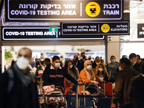 Travellers exit the COVID-19 testing area at Ben Gurion International Airport near Tel Aviv, Israel, Nov. 28, 2021.